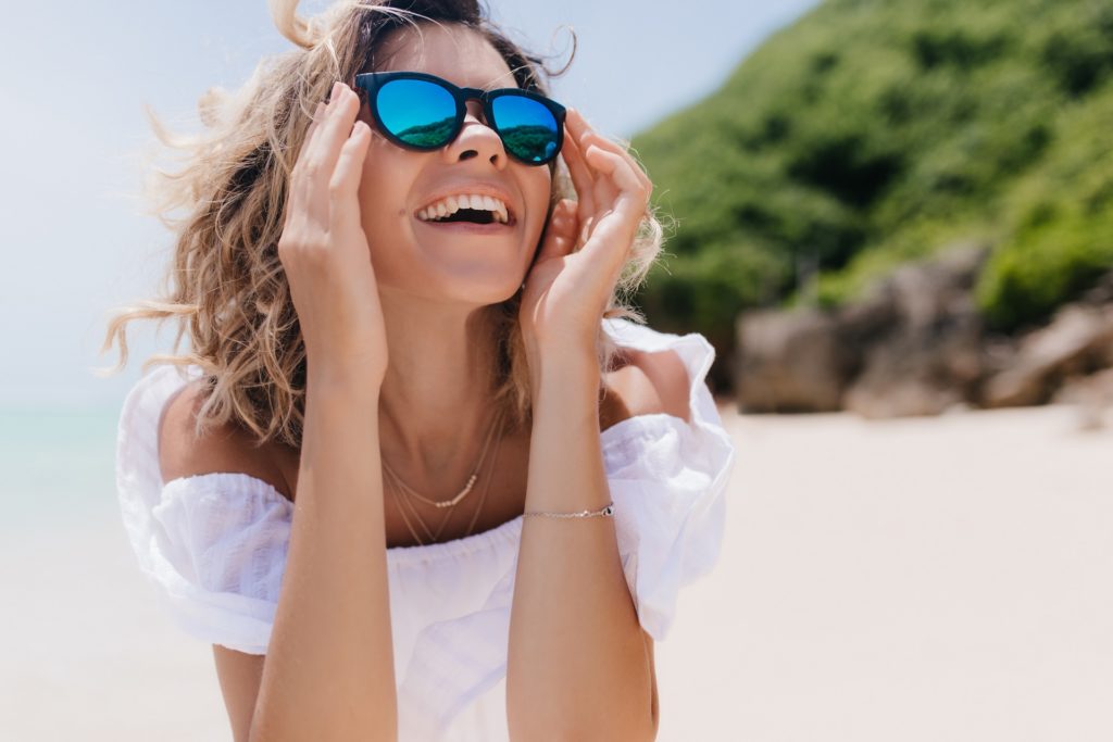 Woman wearing sunglasses on a sunny day at the beach