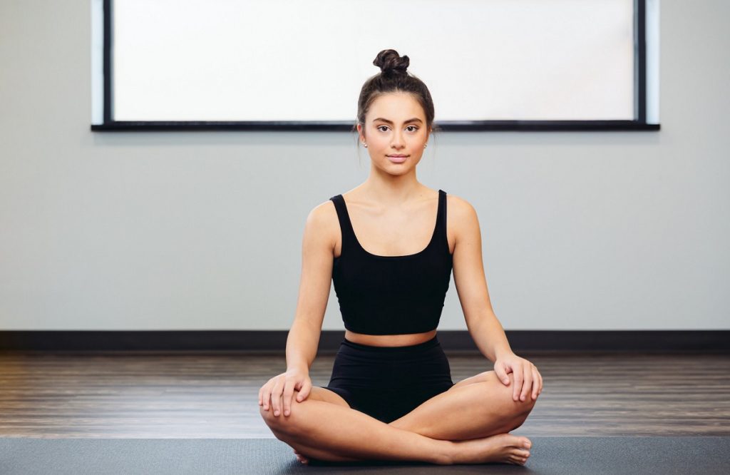 Younger woman doing yoga to relax before LASIK Eye Surgery