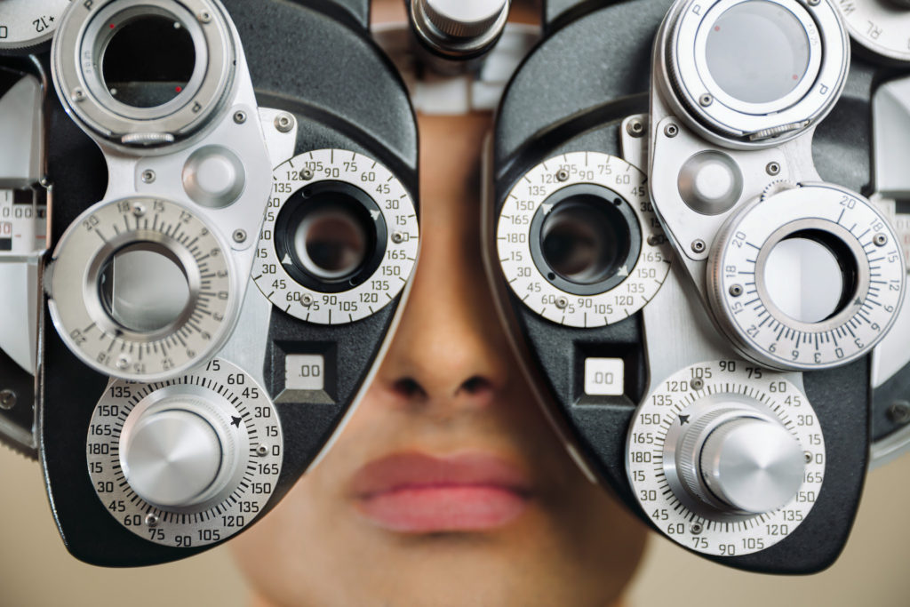 Young woman getting her eyes tested before having laser eye surgery
