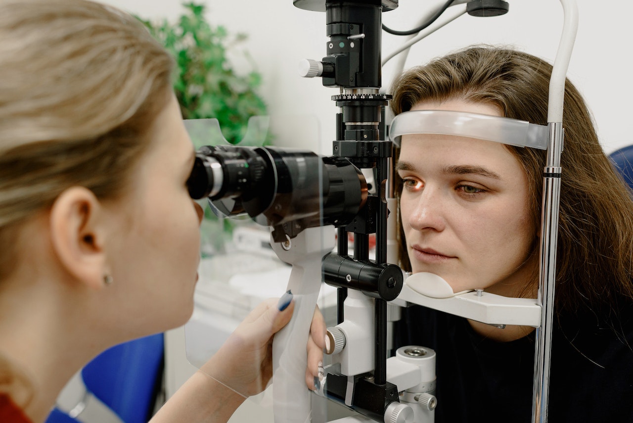 eye doctor checking patient's eye