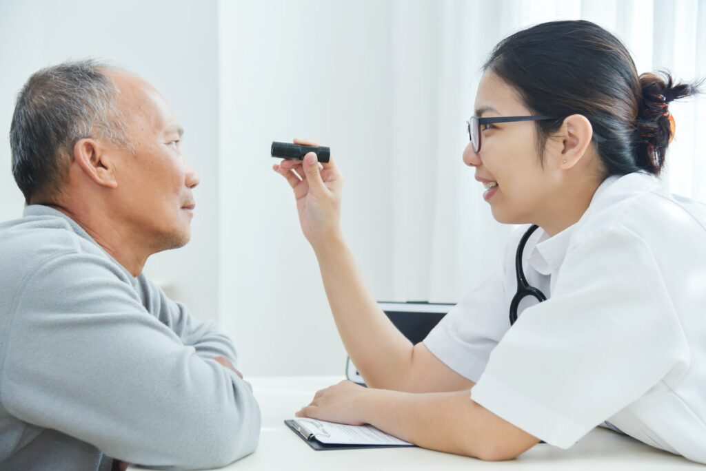 man consulting with eye doctor before cataract surgery
